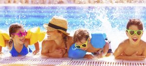 Family enjoying summer fun in neighborhood pool