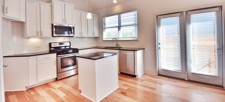 A spacious floor plan with an open kitchen.